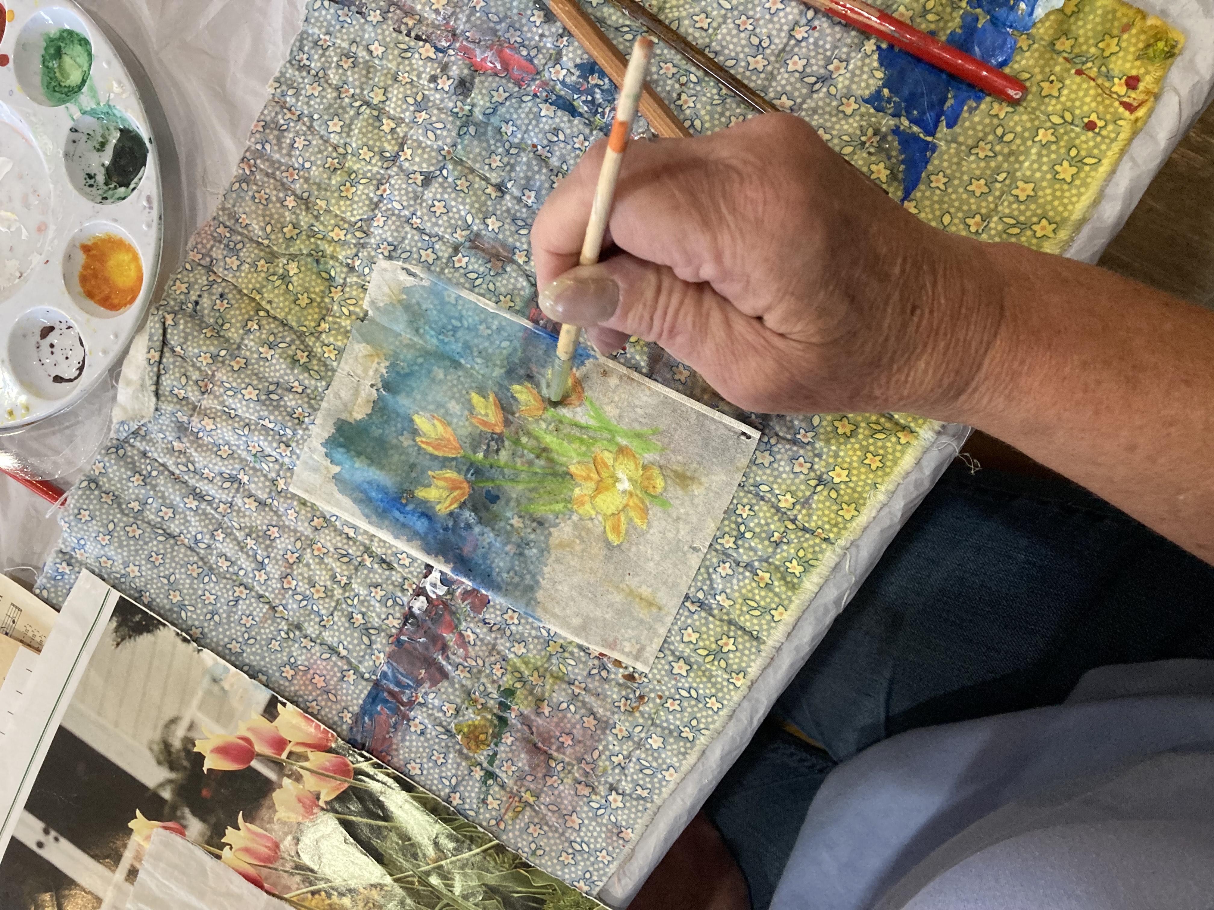Creative aging participant painting flowers