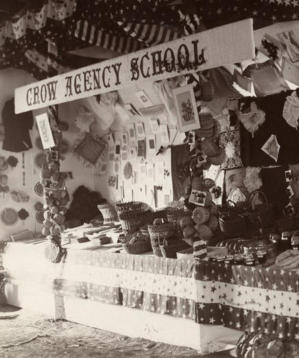 Exhibit at the fair with a banner that reads, Crow Agency School 
