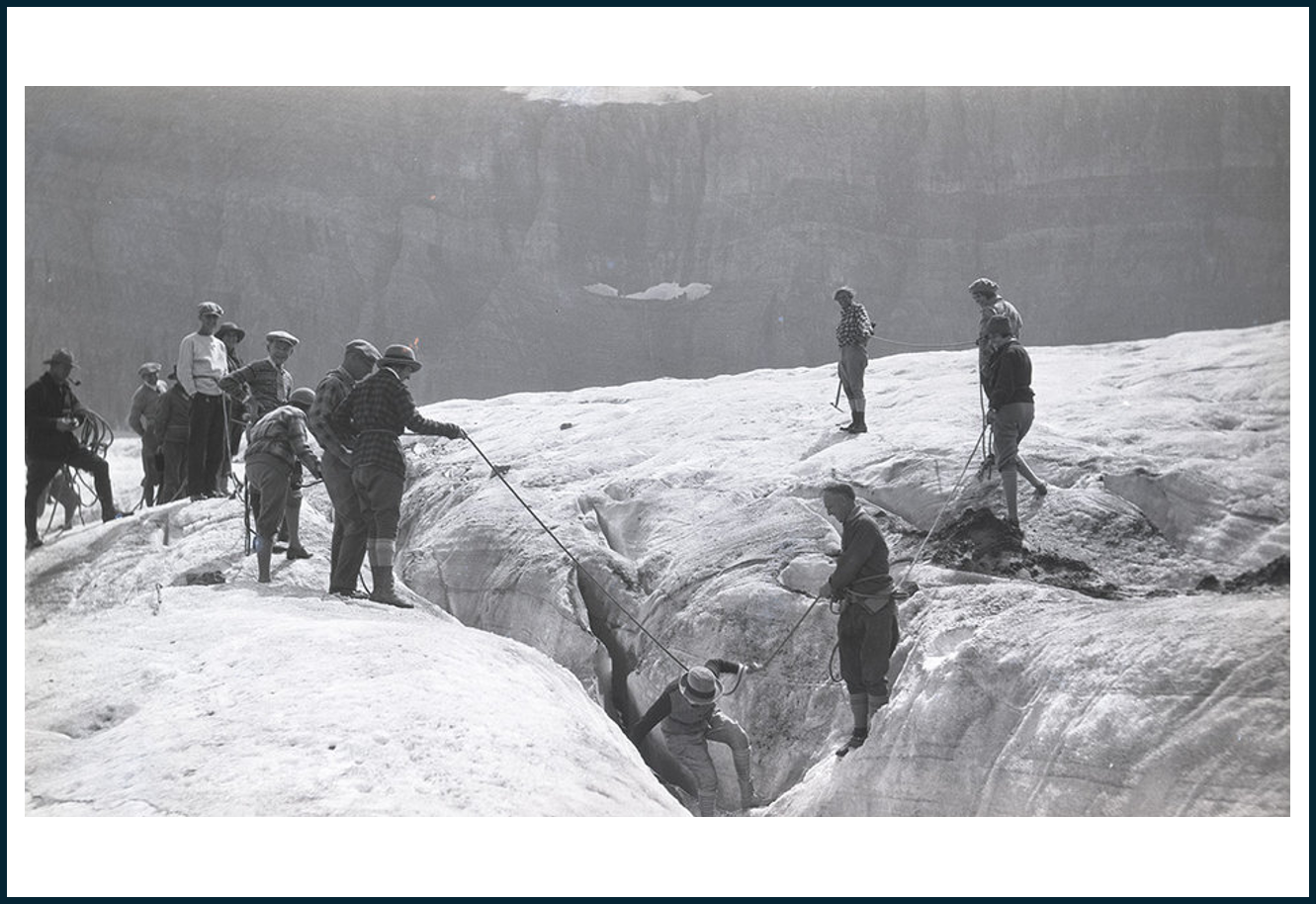 People crossing a glacier crevasse
